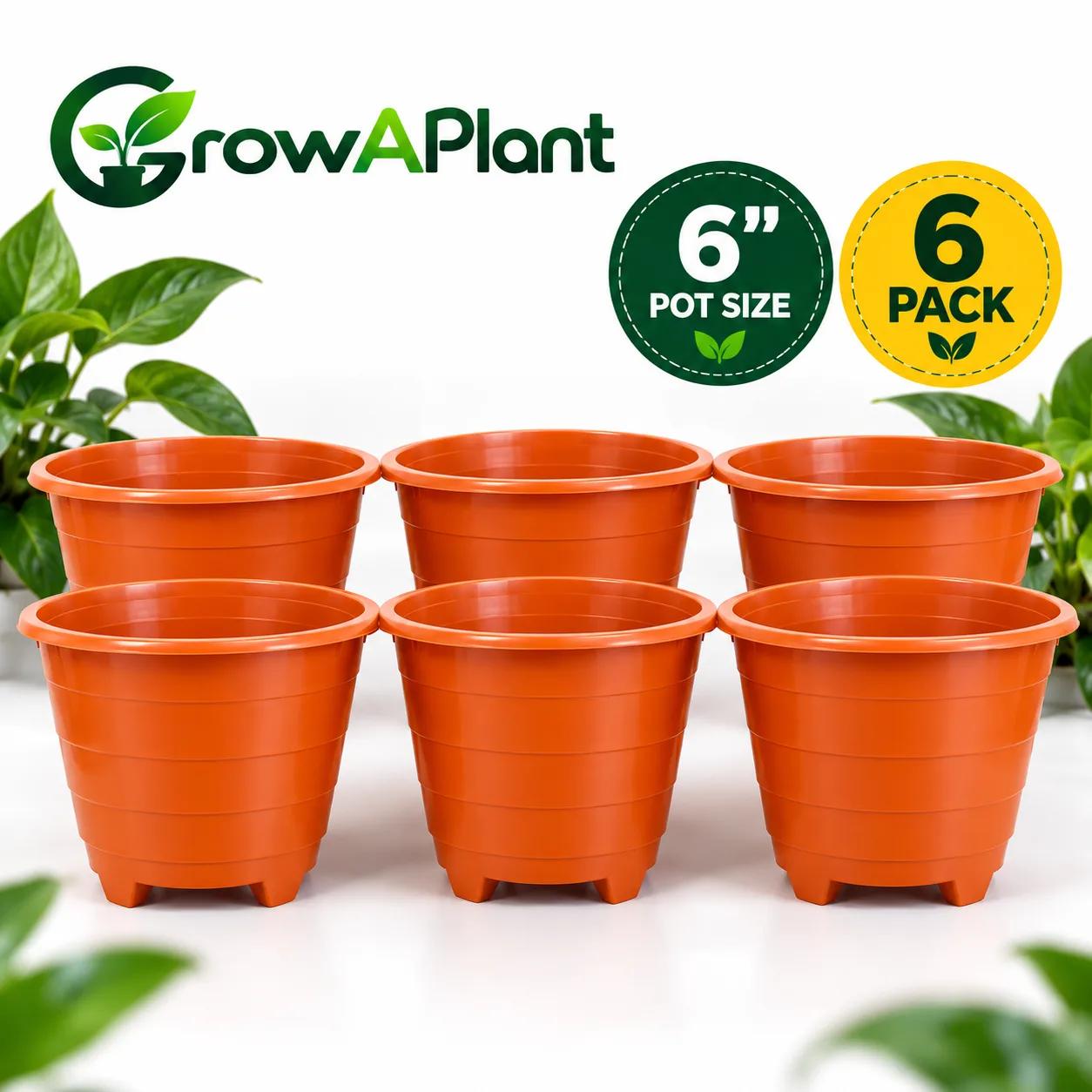 Six empty orange plastic plant pots arranged in two rows on a white surface.